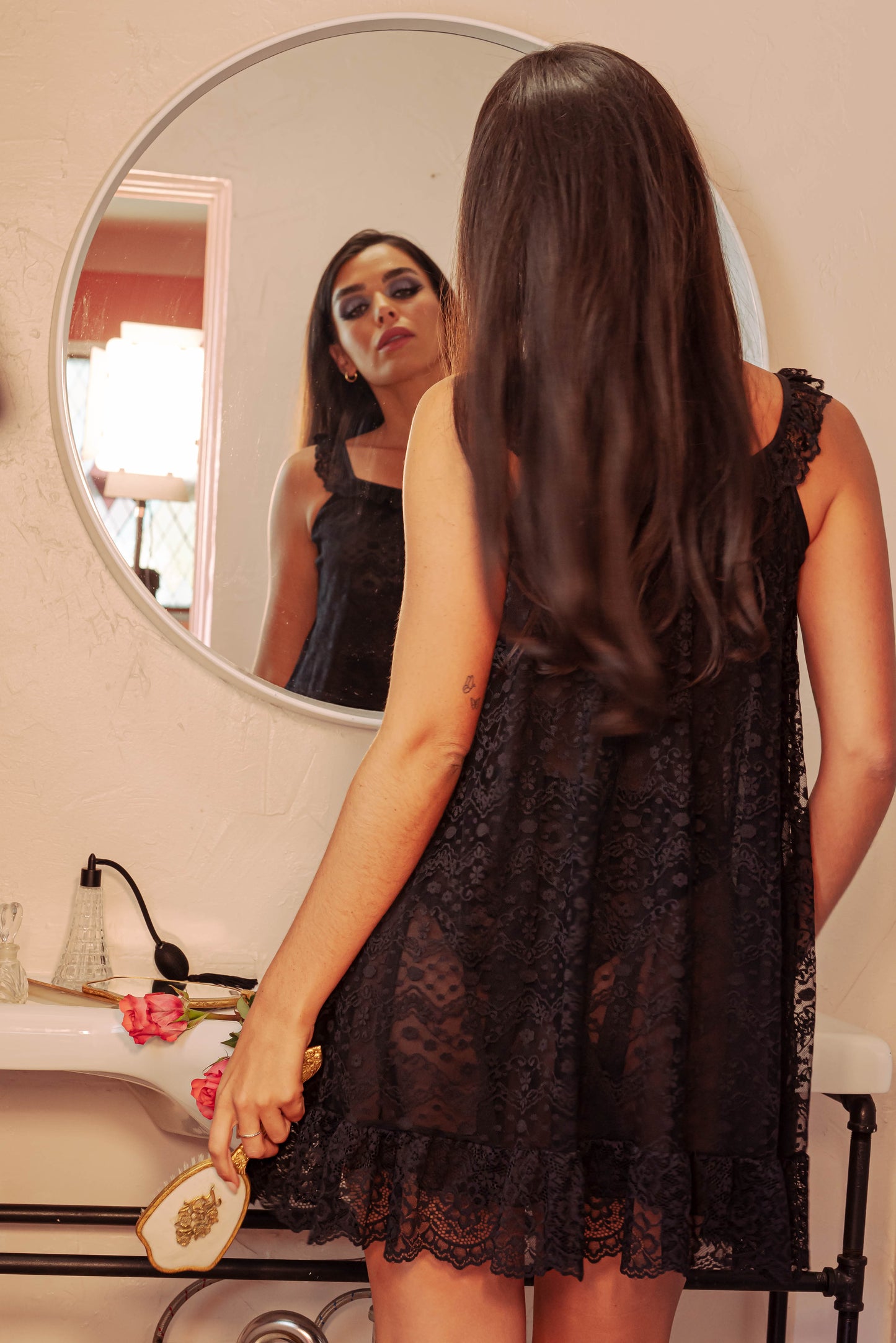 Woman wearing a black lace slip dress