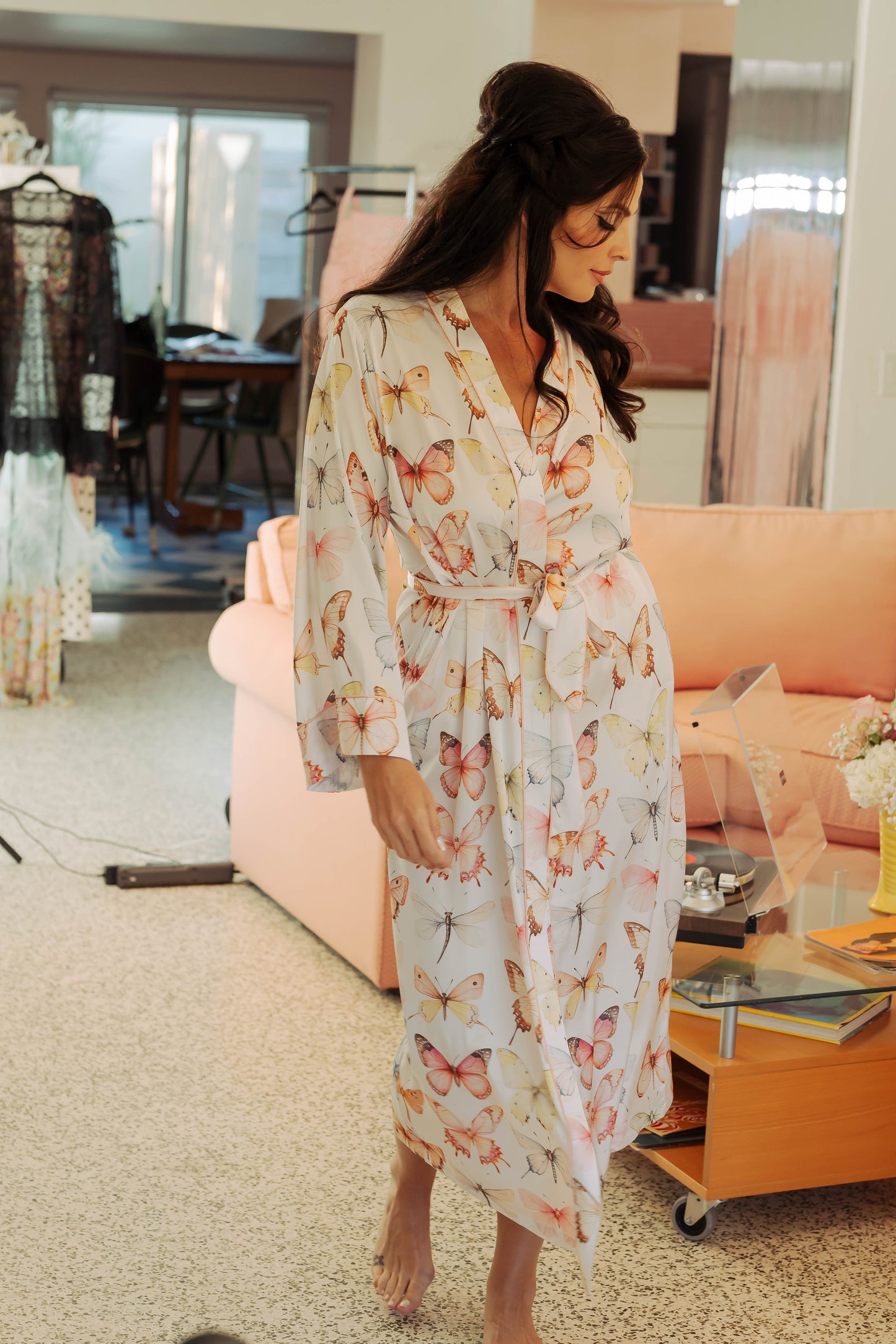 WOMAN IN MAXI ROBE WITH PRINTED PASTEL BUTTERFLIES ON IT 