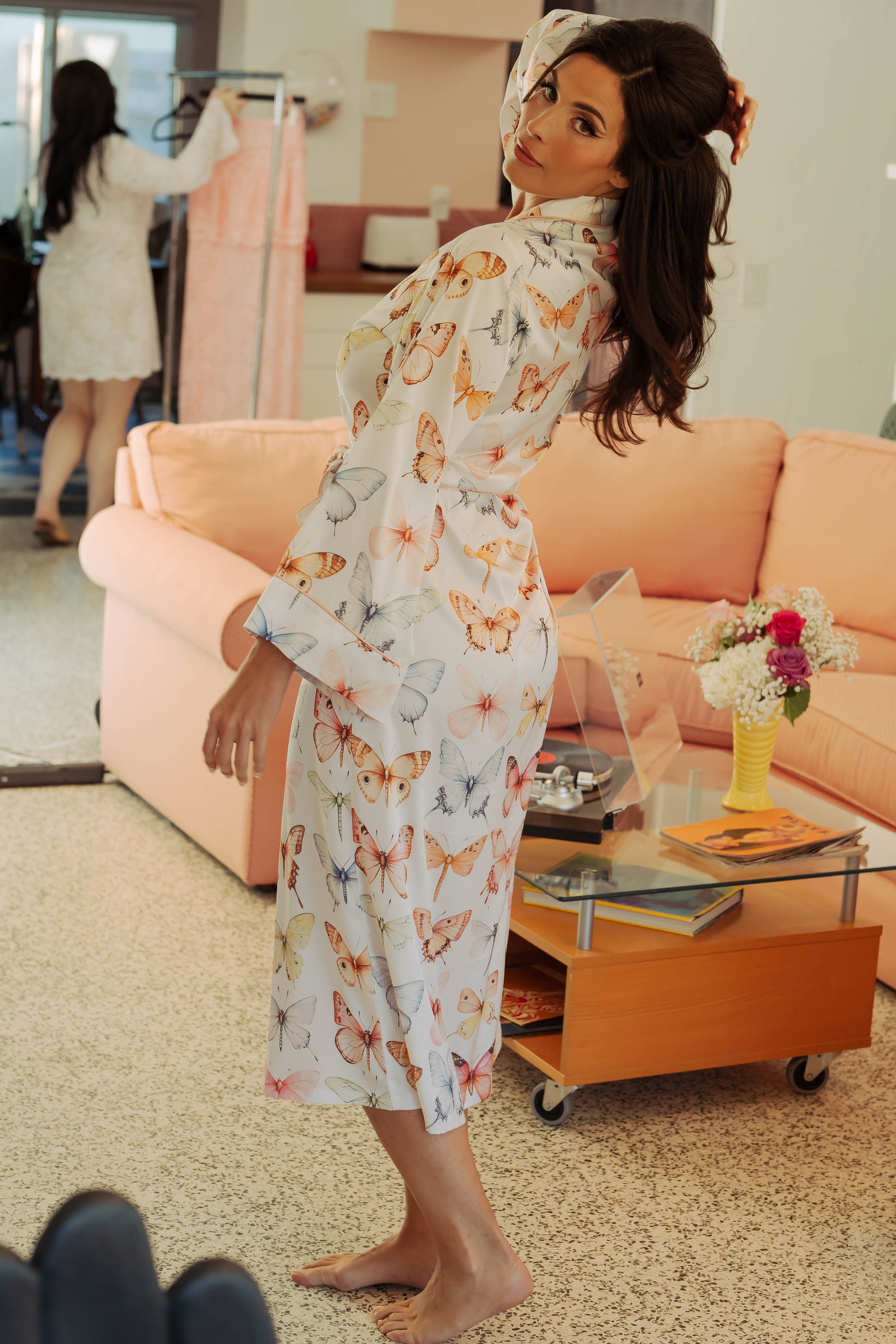 WOMAN IN MAXI ROBE WITH PRINTED PASTEL BUTTERFLIES ON IT 