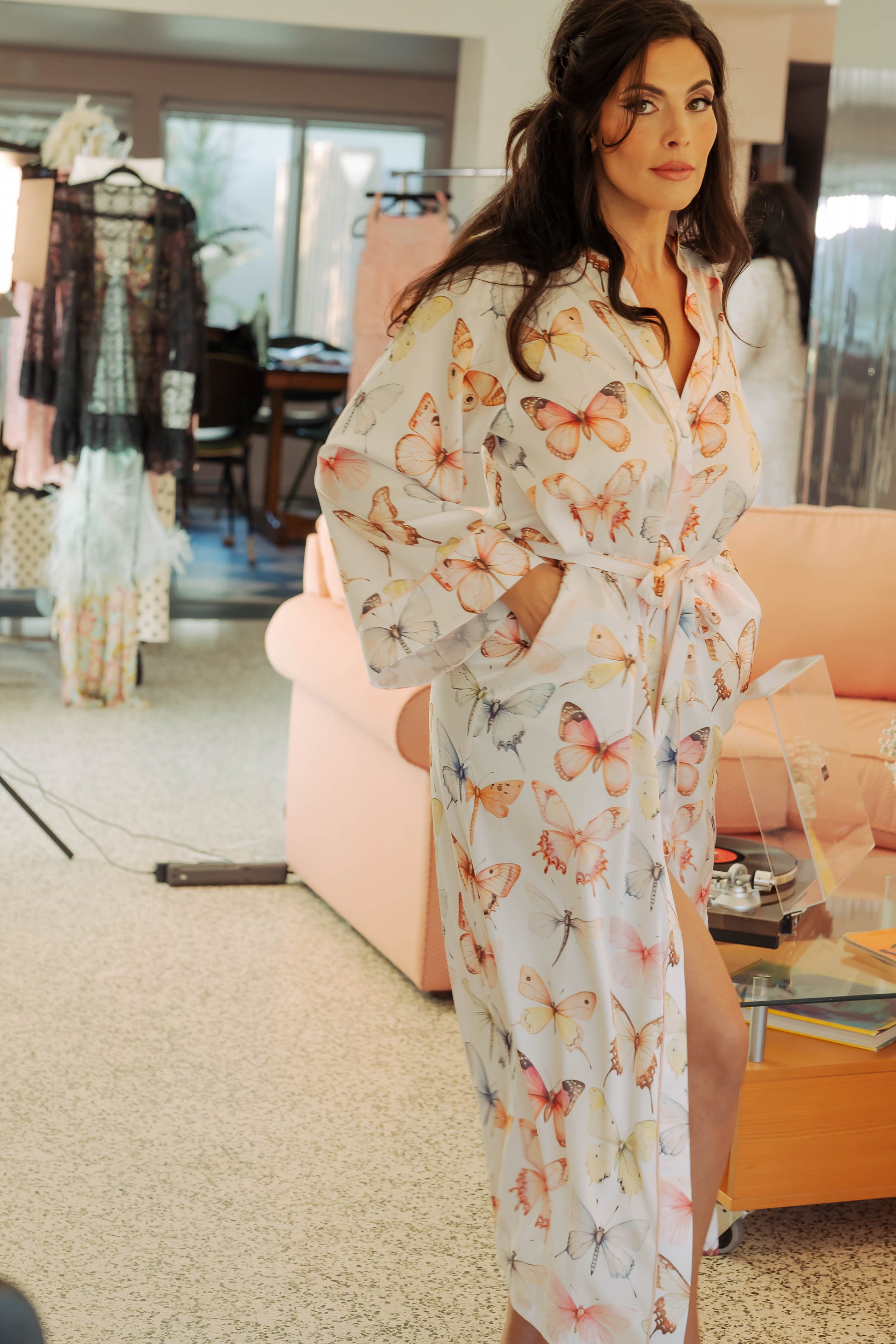 WOMAN IN MAXI ROBE WITH PRINTED PASTEL BUTTERFLIES ON IT 