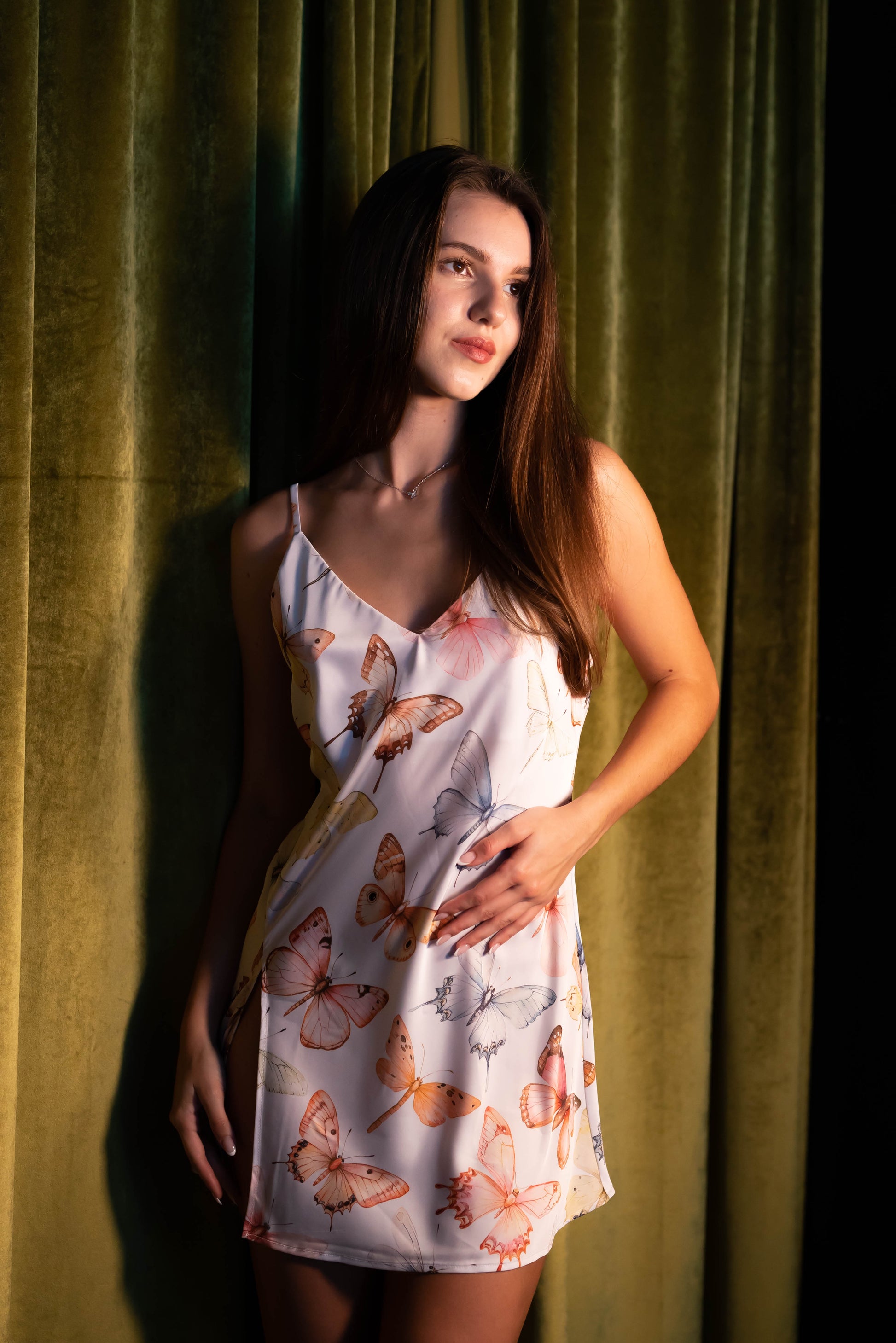 WOMAN IN PASTEL BUTTERFLY PRINT SATIN MINI SLIP 