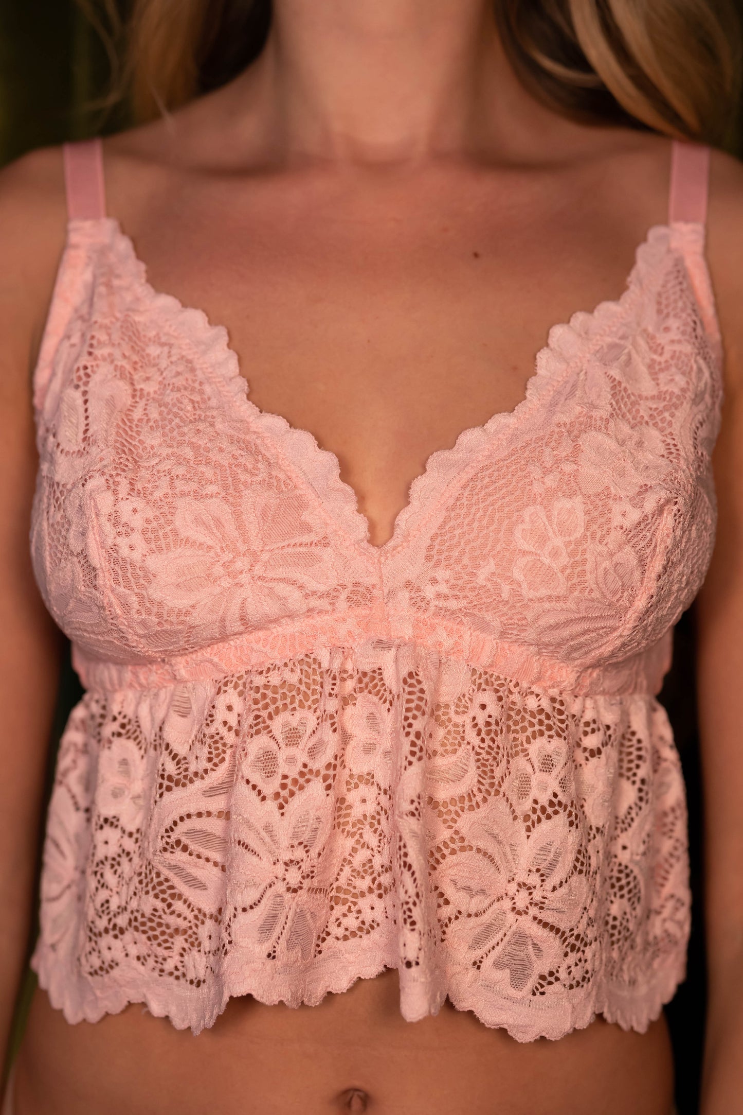 Woman wearing a pink lace top 