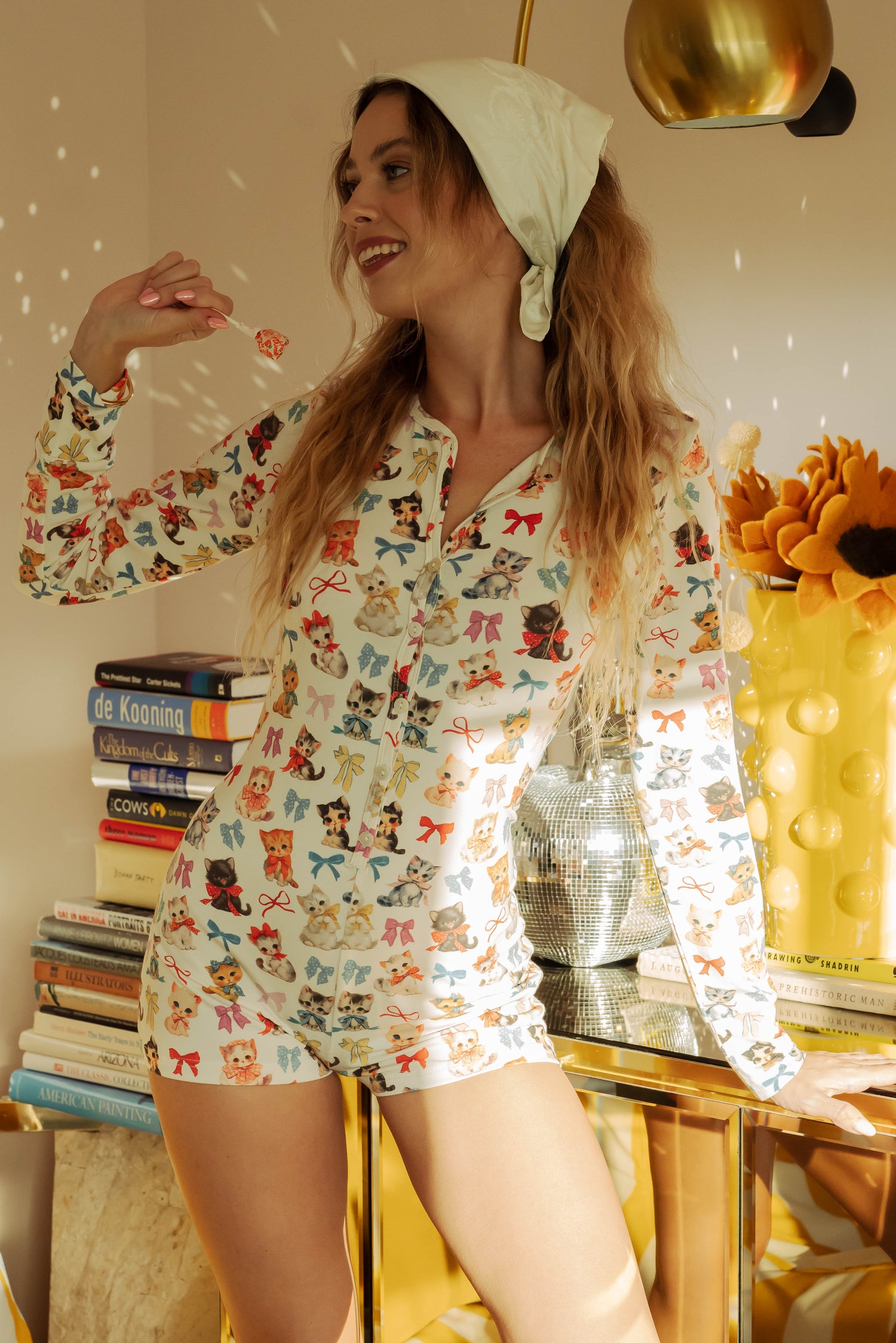 WOMAN IN KITTEN AND BOW PRINTED ONESIE