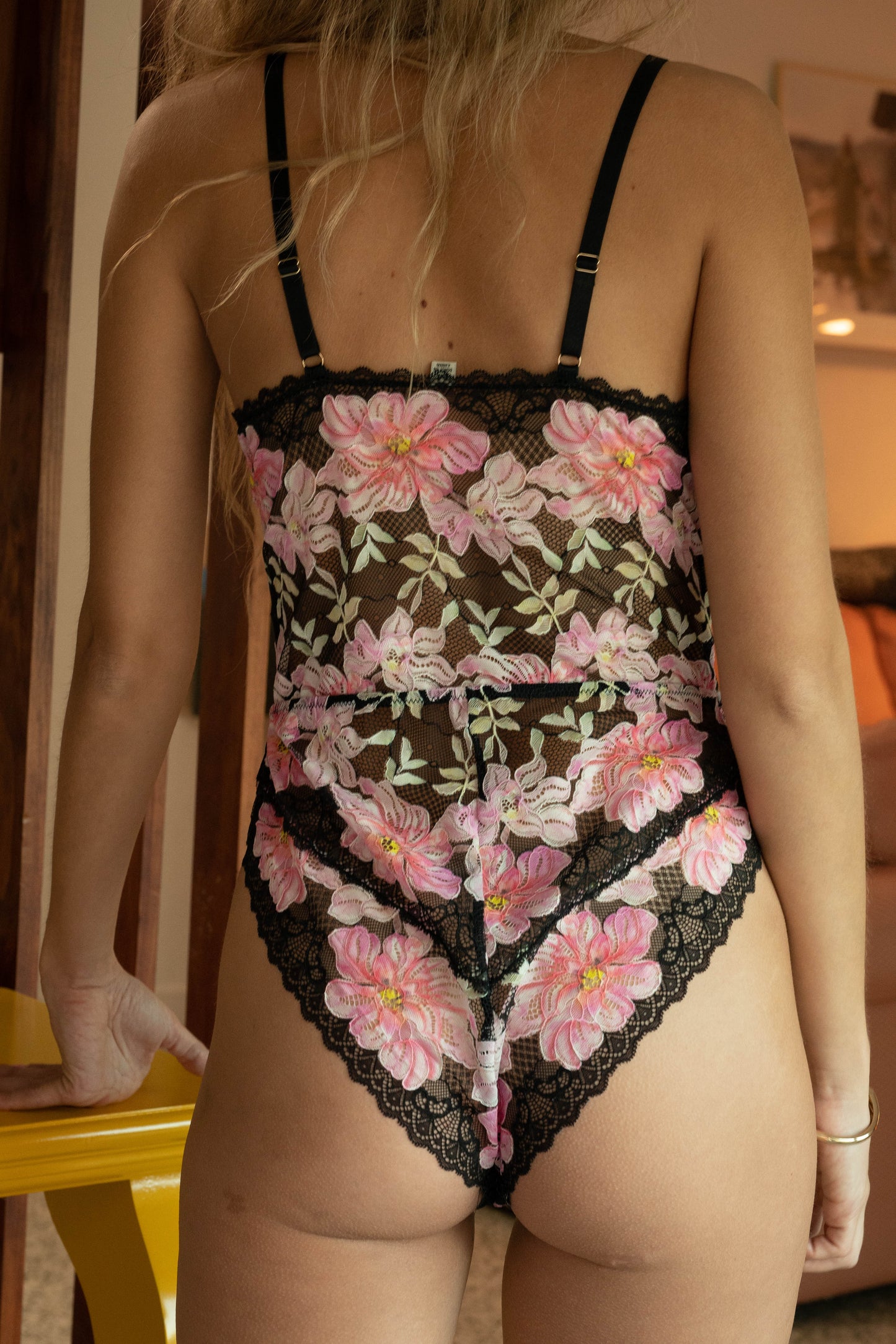WOMAN IN FL0RAL MESH TEDDY