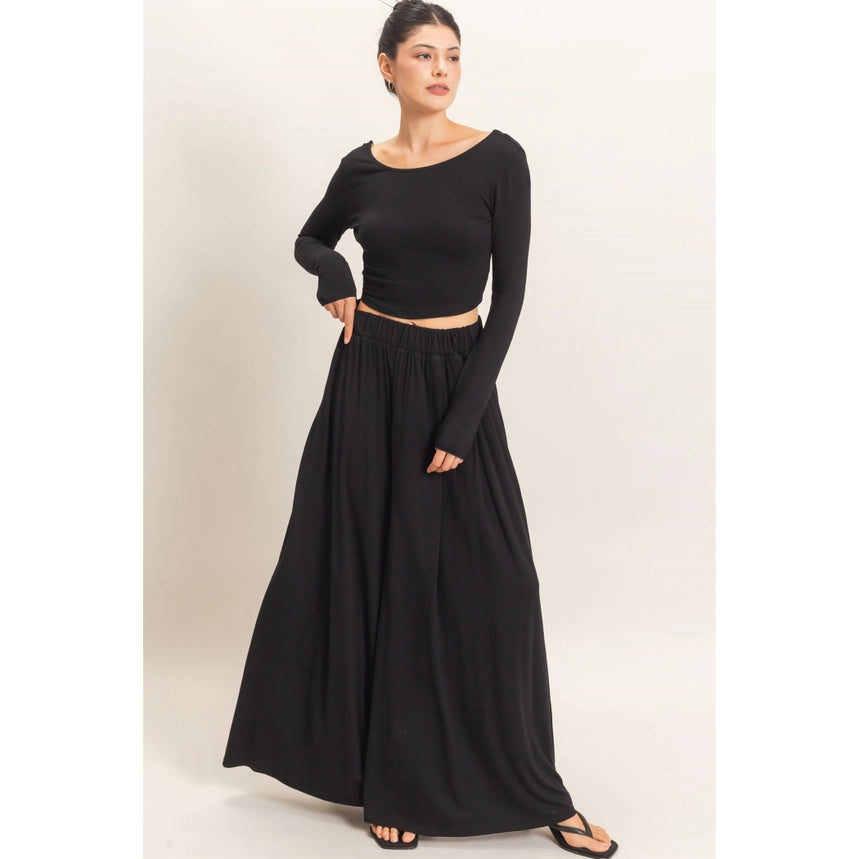 WOMAN MODELING LONG SLEEVE AND WIDE LEG PANT SET IN BLACK