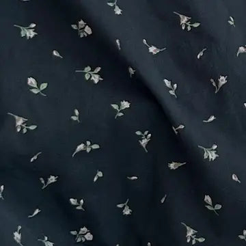 Dark fabric with small white floral patterns