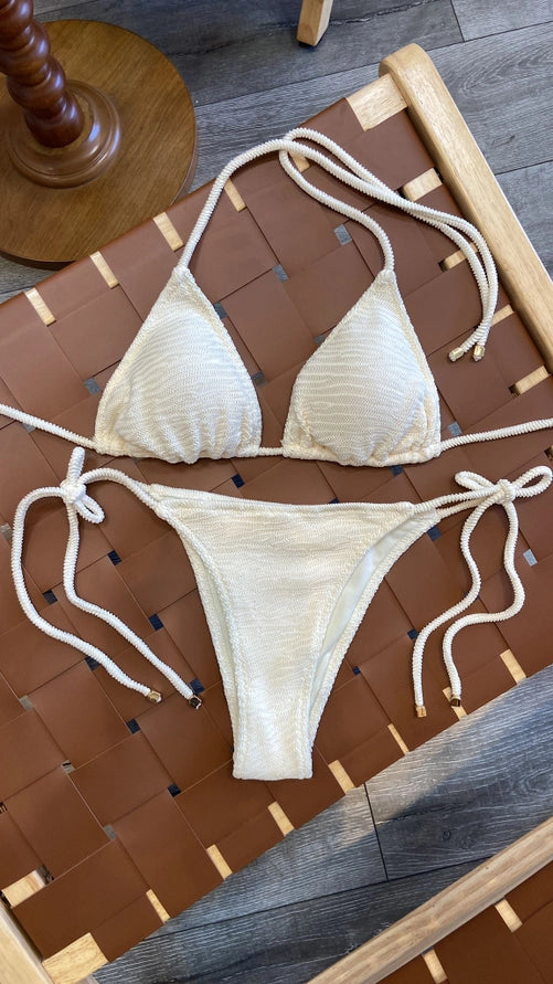 Beige bikini set on a wooden surface
