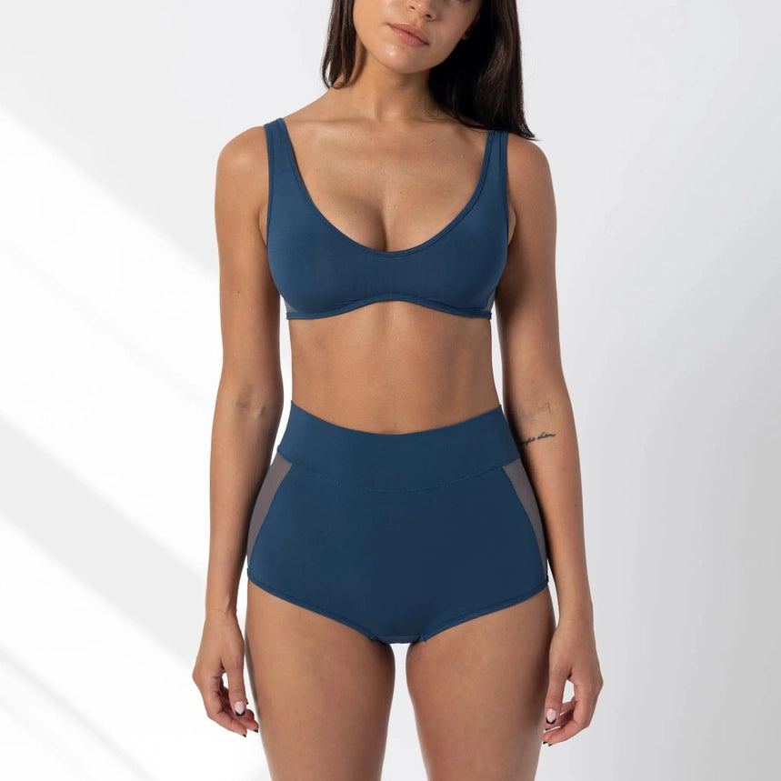 woman modeling Dark denim blue scoop bralette with mesh sides set