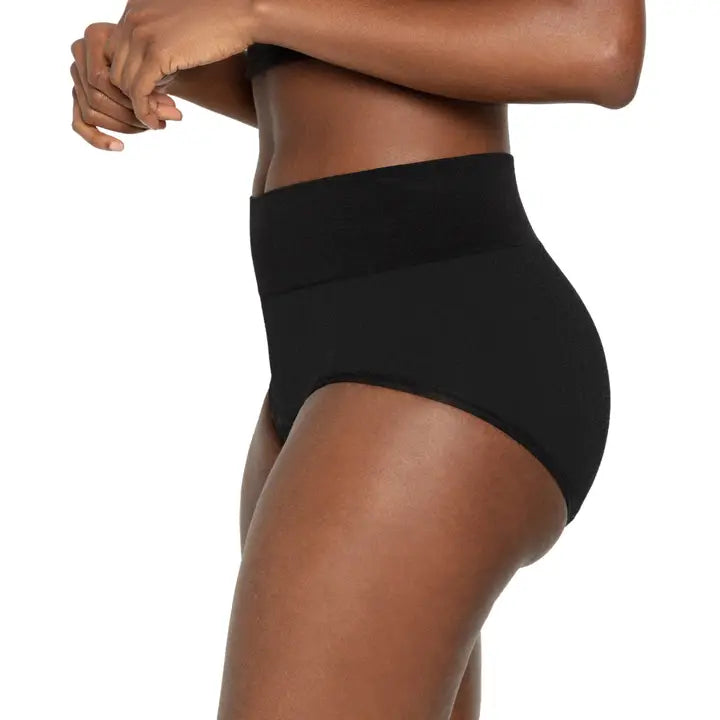 Person wearing black high-waisted underwear on a white background