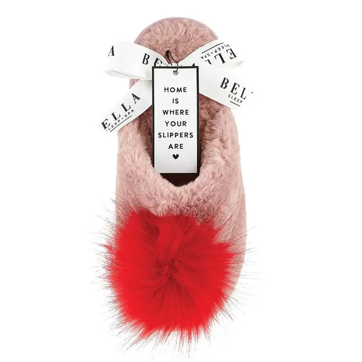 Pair of pink fuzzy slippers with red pom-poms
